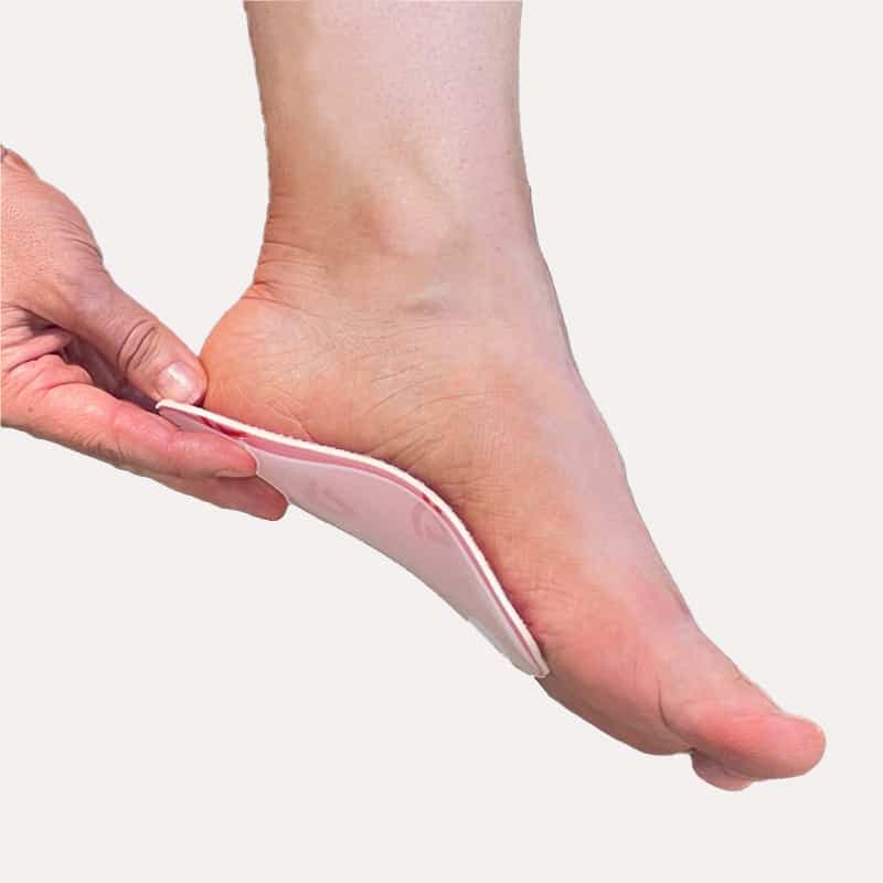 Spriing orthotic positioned under a foot